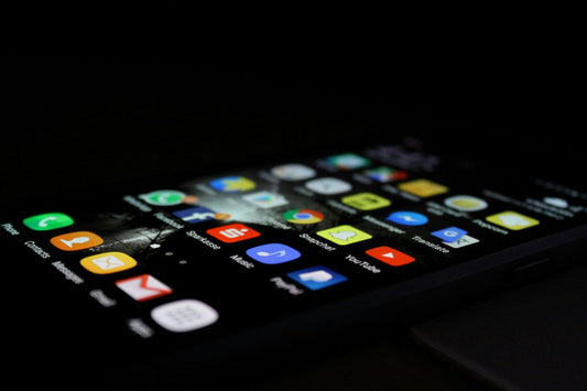 Smartphone screen displaying colourful app icons against a dark background.